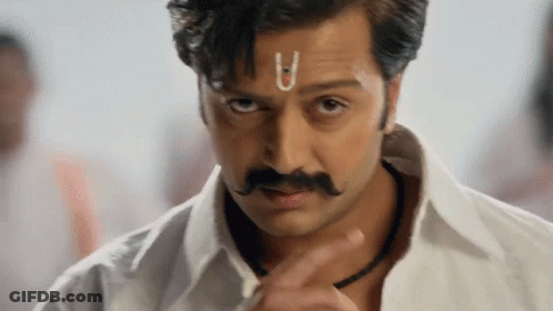 A Man With A Small U On His Forehead Looks At The Camera GIF