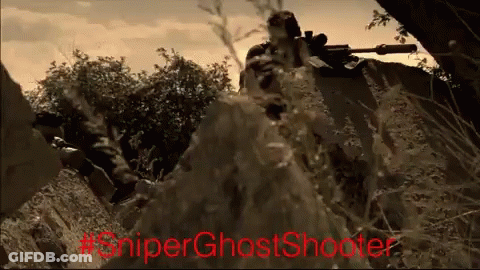 A Man With A Sniper Rifle In A Field With #Sniperghostshooter Written In Red GIF