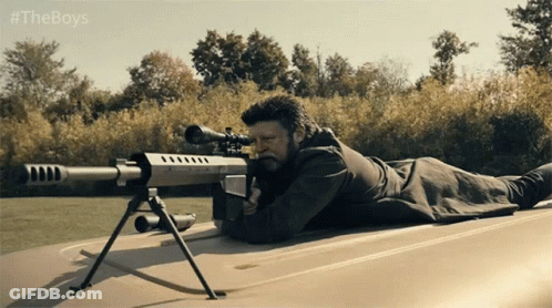 A Man With A Sniper Rifle Is Laying On The Roof Of A Car With #Theboys Written On The Bottom GIF