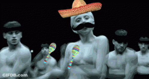 A Man With A Sombrero On His Head And A Mustache Is Surrounded By Other Men GIF