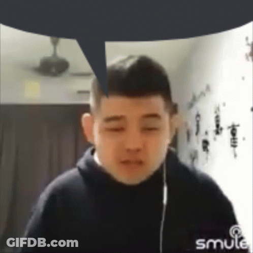 A Man With A Speech Bubble Above His Head Is Wearing Headphones And Looking At The Camera . GIF