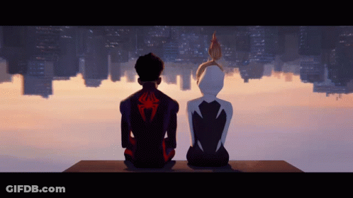 A Man With A Spider On His Back Sits Next To A Girl GIF