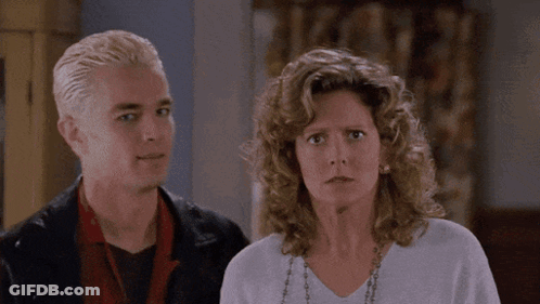 Man With Spike Hair And Curly-Haired Woman GIF