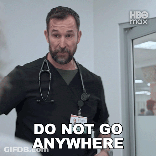A Man With A Stethoscope Around His Neck Is Saying Do Not Go Anywhere GIF