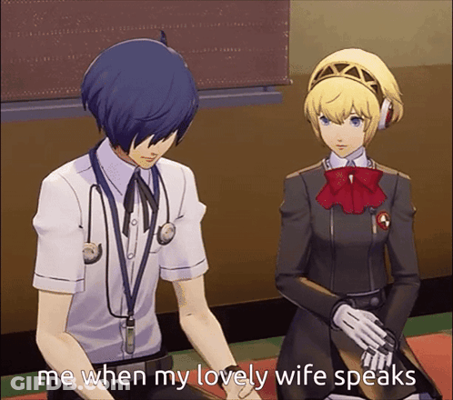 A Man With A Stethoscope Around His Neck Sits Next To A Woman With A Red Bow On Her Head GIF