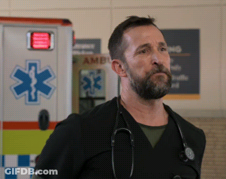 A Man With A Stethoscope Around His Neck Stands In Front Of An Ambulance GIF