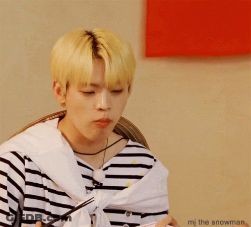A Man With A Striped Shirt Is Eating Something With Chopsticks And The Words Mj The Snowman Below Him GIF