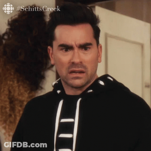 A Man With A Surprised Look On His Face And The Hashtag Schitts Creek GIF