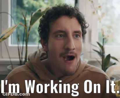 A Man With A Surprised Look On His Face And The Words " I 'M Working On It " Below Him GIF