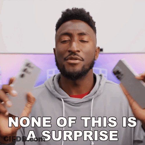 A Man With A Surprised Look On His Face And The Words None Of This Is A Surprise Below Him GIF