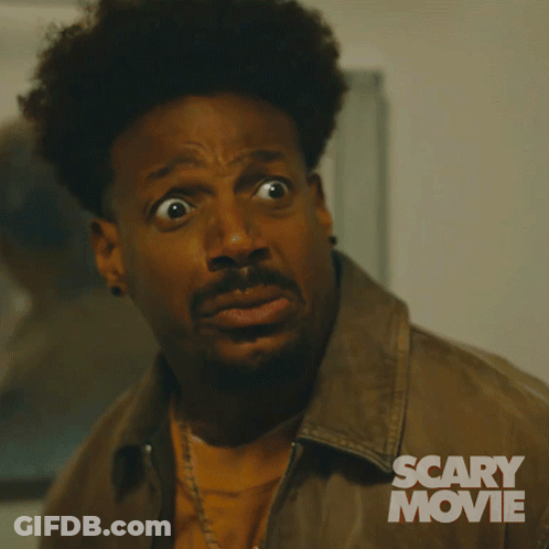 A Man With A Surprised Look On His Face Is In A Scary Movie Advertisement GIF
