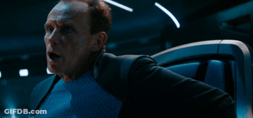 A Man With A Surprised Look On His Face Is Next To A Sign That Says Who GIF