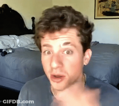 A Man With A Surprised Look On His Face Is Pointing At The Camera GIF