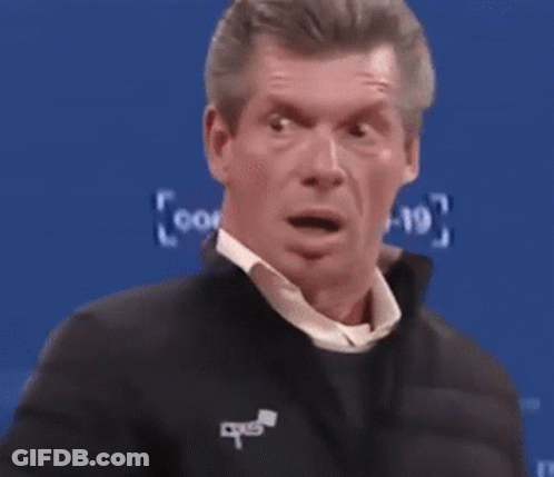 A Man With A Surprised Look On His Face Is Standing In Front Of A Blue Background With The Numbers 1-9 On It GIF