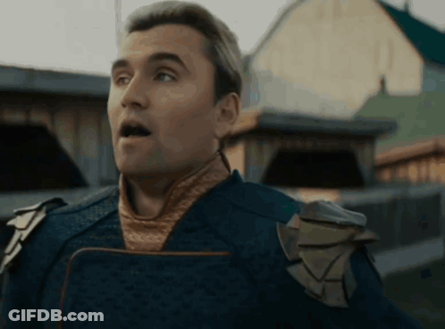 A Man With A Surprised Look On His Face Is Wearing A Blue Costume GIF