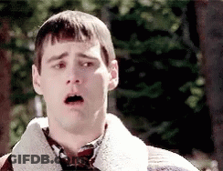 A Man With A Surprised Look On His Face Is Wearing A Sweater And Plaid Shirt GIF