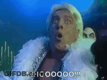 A Man With A Surprised Look On His Face Is Wearing A White Fur Coat And A White Feather Boa . GIF