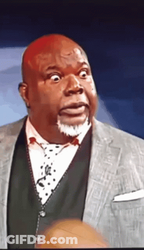 A Man With A Surprised Look On His Face Wearing A Suit And Tie GIF