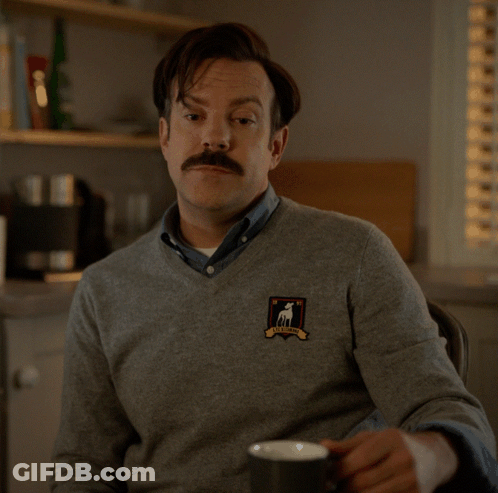 A Man With A Sweater That Says I 'D Call You A Big Dumb Poo-Poo Face GIF