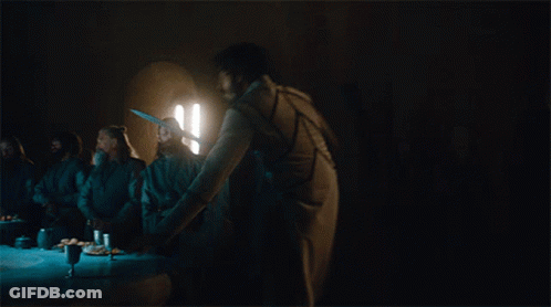 A Man With A Sword Is Standing On A Table In A Dark Room GIF