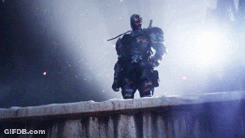 A Man With A Sword Is Standing On A Wall GIF