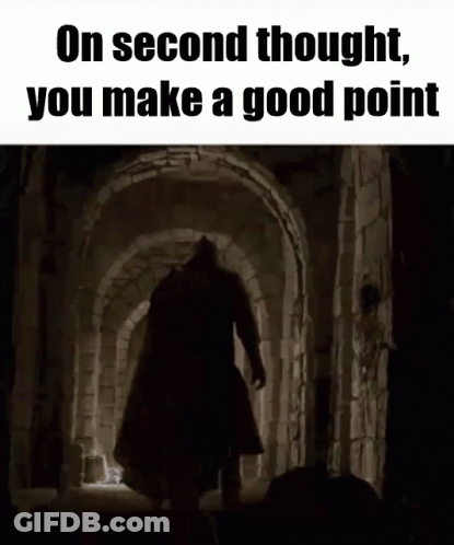 A Man With A Sword Is Walking Through A Dark Tunnel . GIF