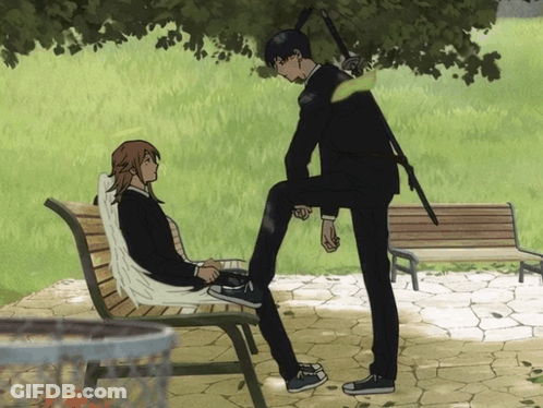 A Man With A Sword Standing Next To A Woman On A Bench GIF
