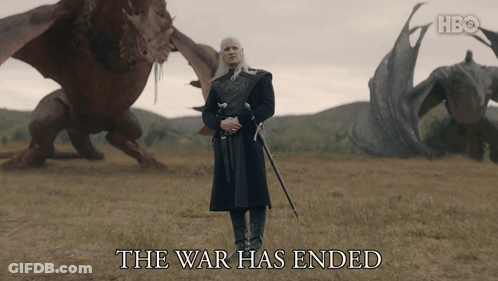 A Man With A Sword Stands In A Field With Dragons And The Words The War Has Ended Below Him GIF