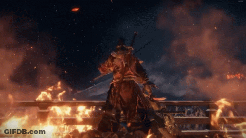 A Man With A Sword Stands In Front Of A Burning Building GIF