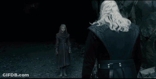 A Man With A Sword Stands In Front Of A Giant Monster GIF