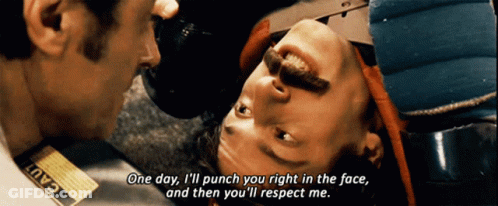 A Man With A Tag That Says Cad On It Is Talking To Another Man GIF