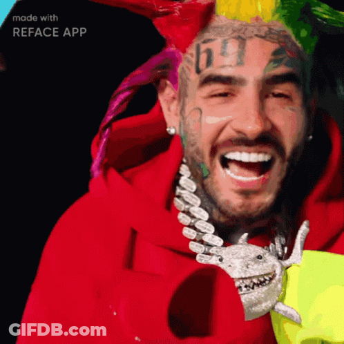 A Man With A Tattoo Of The Number 69 On His Face Is Smiling GIF