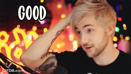 A Man With A Tattoo On His Arm Holds His Hand To His Head With The Word Good Above Him GIF