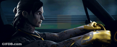 A Man With A Tattoo On His Arm Is Driving A Car At Night GIF