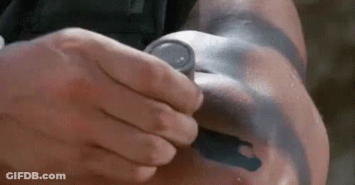 A Man With A Tattoo On His Arm Is Holding A Stethoscope . GIF