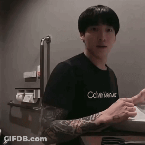 A Man With A Tattoo On His Arm Is Wearing A Black Calvin Klein Shirt GIF