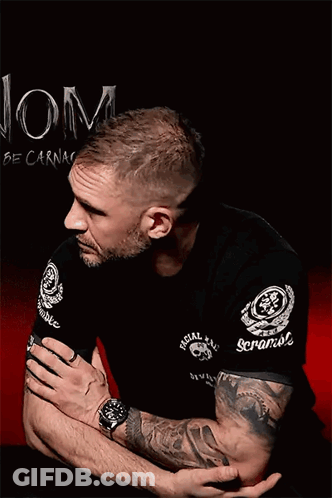 A Man With A Tattoo On His Arm Is Wearing A Black Shirt That Says Special Forces GIF
