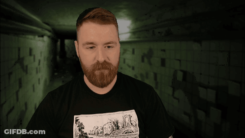 A Man With A Tattoo On His Arm Is Wearing A Black Shirt With A Picture Of A Sheep On It GIF