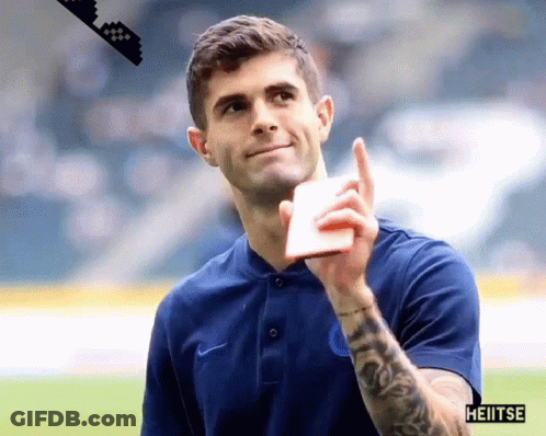 A Man With A Tattoo On His Arm Is Wearing A Blue Shirt That Says Heiitse GIF