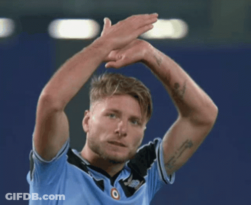 A Man With A Tattoo On His Arm Is Wearing A Blue Shirt With The Word Jeep On It GIF