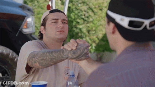 Man With Tattoo Shakes Hands With Another Man GIF