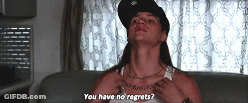 A Man With A Tattoo On His Chest Is Sitting On A Couch And Asking If He Has No Regrets . GIF