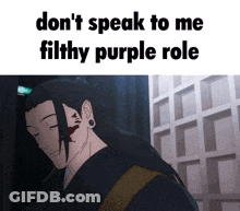 A Man With A Tattoo On His Ear Is Standing In Front Of A Building And A Sign That Says Do N't Speak GIF