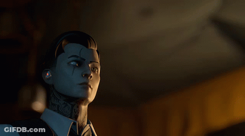 A Man With A Tattoo On His Face Is Looking At Something In A Dark Room GIF