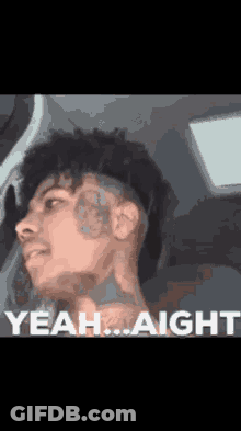 A Man With A Tattoo On His Face Is Sitting In A Car And Says Yeah ... Aight GIF