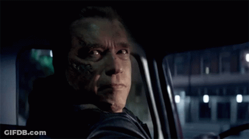 A Man With A Tattoo On His Face Is Smiling While Driving A Car GIF