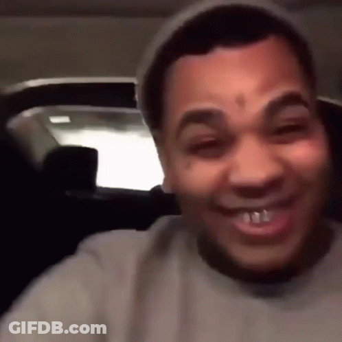 A Man With A Tattoo On His Forehead Is Smiling And Wearing A Hat GIF