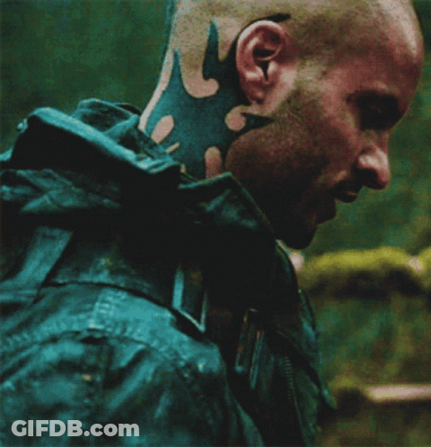 A Man With A Tattoo On His Neck Is Wearing A Jacket GIF