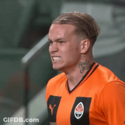 A Man With A Tattoo On His Neck Is Wearing An Orange Shirt With The Letter Y On It GIF
