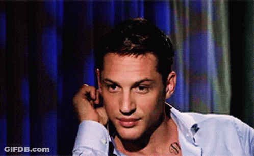 A Man With A Tattoo On His Neck Looks To The Side GIF